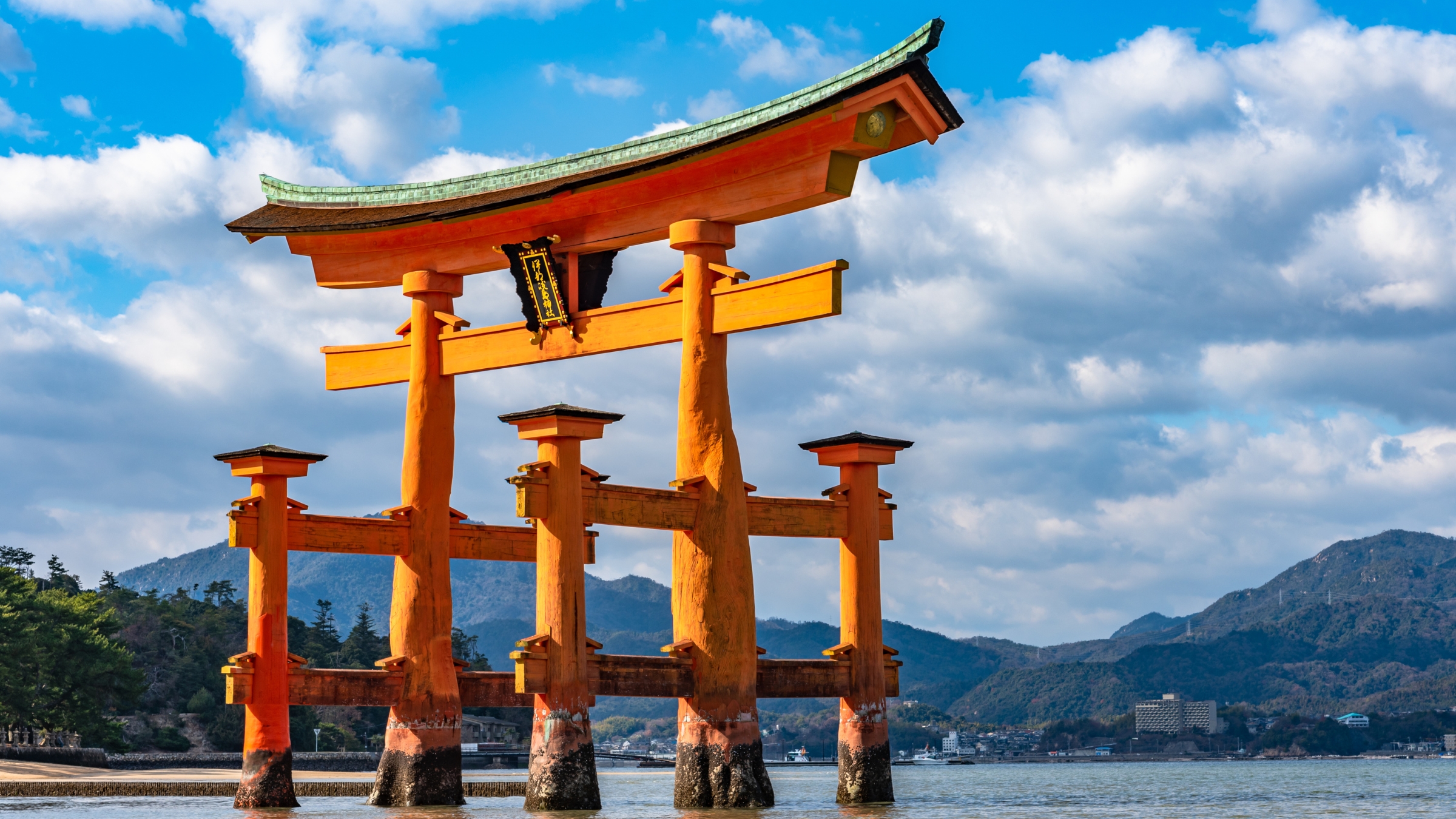 Floating red giant Grand O-Torii gate stands in Miyajima island bay beach, Hiroshima